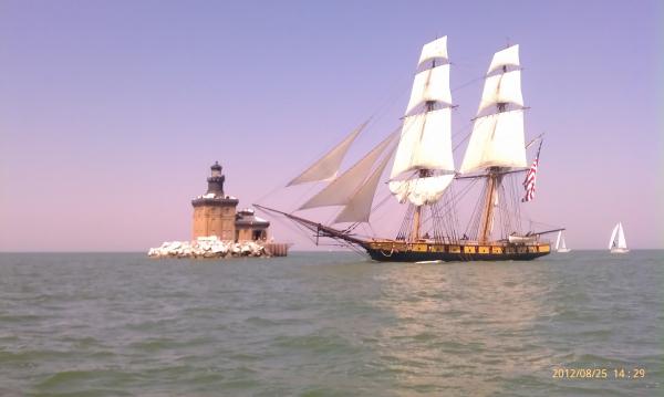 I took this photo at the Toledo Harbor light as the Niagra made its way past the Toledo Harbor light on its way in to Toledo for Navy Week! Beautiful ship!