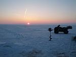 Enjoying a beautiful Erie sunrise 5 mile out of Camp Perry. No fish on the ice yet.